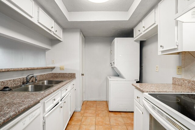 7700 Creekbend Dr Unit 6, Houston, TX 77071 - kitchen featuring white appliances, stacked washer / drying machine, white cabinets, and light tile patterned floors