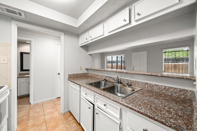 7700 Creekbend Dr Unit 6, Houston, TX 77071 - kitchen featuring white appliances, white cabinetry, light tile patterned floors, and dark countertops