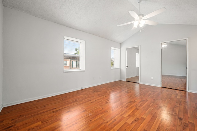 7700 Creekbend Dr Unit 6, Houston, TX 77071 - unfurnished bedroom with wood finished floors, vaulted ceiling, a textured ceiling, and a ceiling fan