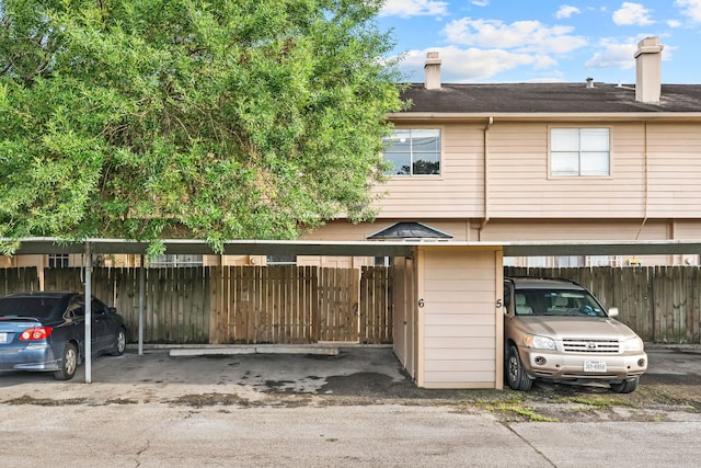 7700 Creekbend Dr Unit 6, Houston, TX 77071 - view of front facade with covered parking, a chimney, and a shingled roof