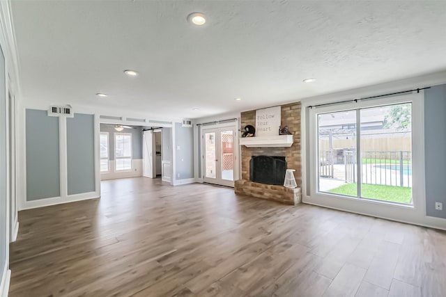 1711 Earl Of Dunmore St, Katy, TX 77449 - unfurnished living room with wood finished floors, a large fireplace, recessed lighting, and ceiling fan