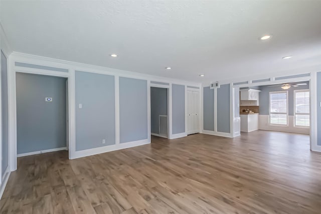 1711 Earl Of Dunmore St, Katy, TX 77449 - unfurnished living room featuring ornamental molding, wood finished floors, a ceiling fan, and recessed lighting