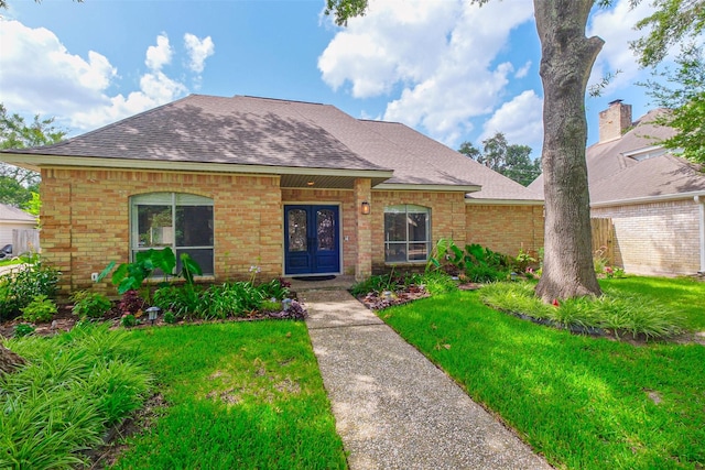 1711 Earl Of Dunmore St, Katy, TX 77449 - view of front facade featuring french doors, brick siding, a shingled roof, and a front lawn