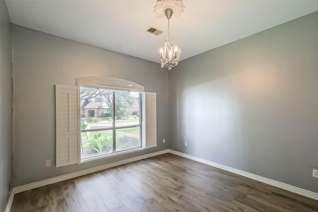 1711 Earl Of Dunmore St, Katy, TX 77449 - empty room with a chandelier and dark wood-style flooring