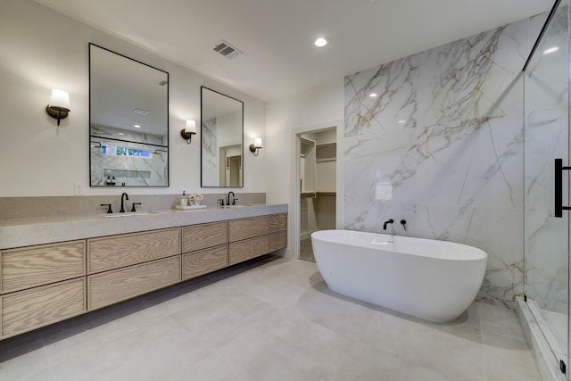 6110 Yarwell Dr, Houston, TX 77096 - full bath featuring double vanity, a soaking tub, a walk in closet, a marble finish shower, and recessed lighting