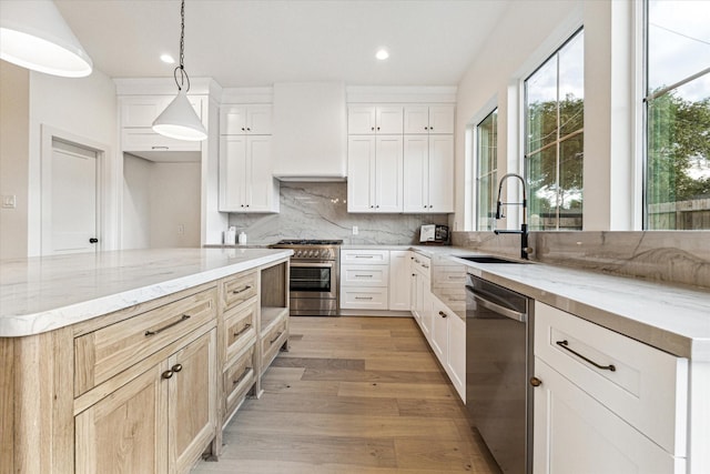 6110 Yarwell Dr, Houston, TX 77096 - kitchen featuring stainless steel appliances, light stone countertops, tasteful backsplash, light wood-style floors, and recessed lighting
