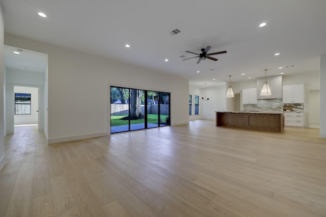 6110 Yarwell Dr, Houston, TX 77096 - unfurnished living room featuring recessed lighting, light wood-style floors, and a ceiling fan
