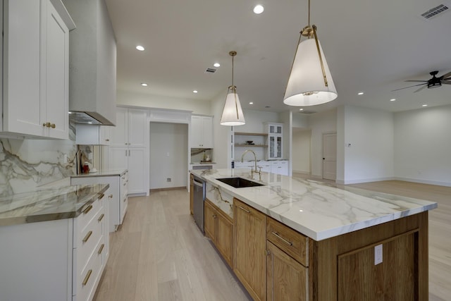 6110 Yarwell Dr, Houston, TX 77096 - kitchen featuring stainless steel dishwasher, light wood-style flooring, a ceiling fan, white cabinetry, and a spacious island