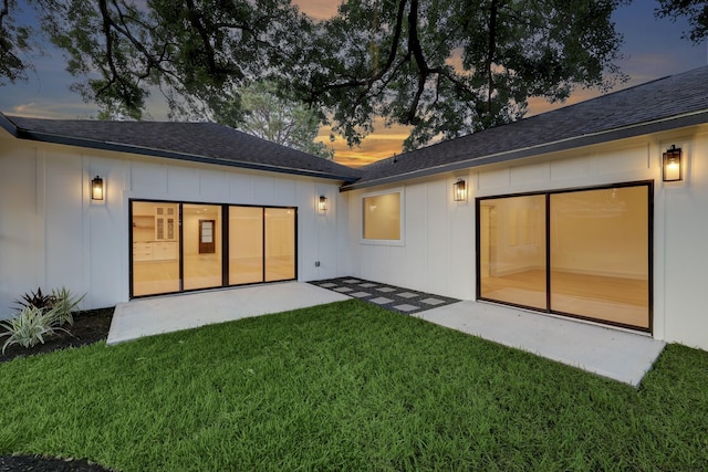 6110 Yarwell Dr, Houston, TX 77096 - back of property featuring a lawn, a patio, board and batten siding, and a shingled roof