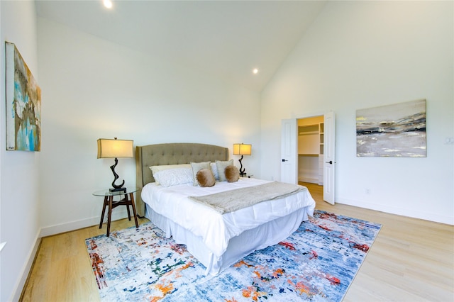 2310 Reinerman St, Houston, TX 77007 - bedroom with light wood-type flooring, recessed lighting, high vaulted ceiling, and a walk in closet