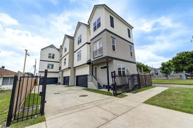 2310 Reinerman St, Houston, TX 77007 - view of front facade featuring driveway, a gate, an attached garage, and board and batten siding