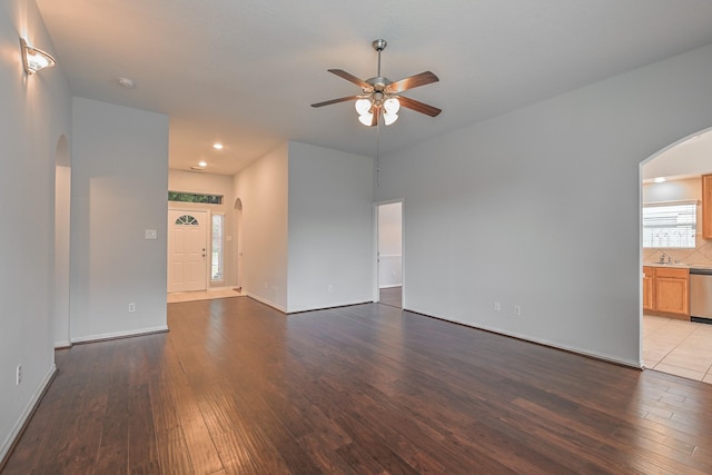1518 Bugle Run Dr, Katy, TX 77449 - unfurnished living room with arched walkways, ceiling fan, hardwood / wood-style floors, and recessed lighting