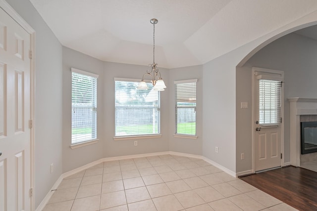 1518 Bugle Run Dr, Katy, TX 77449 - unfurnished dining area featuring plenty of natural light, a chandelier, a tile fireplace, and arched walkways