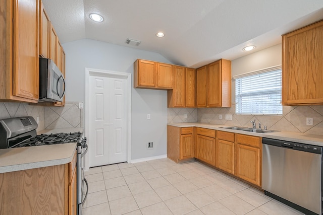 1518 Bugle Run Dr, Katy, TX 77449 - kitchen featuring appliances with stainless steel finishes, vaulted ceiling, light countertops, tasteful backsplash, and recessed lighting