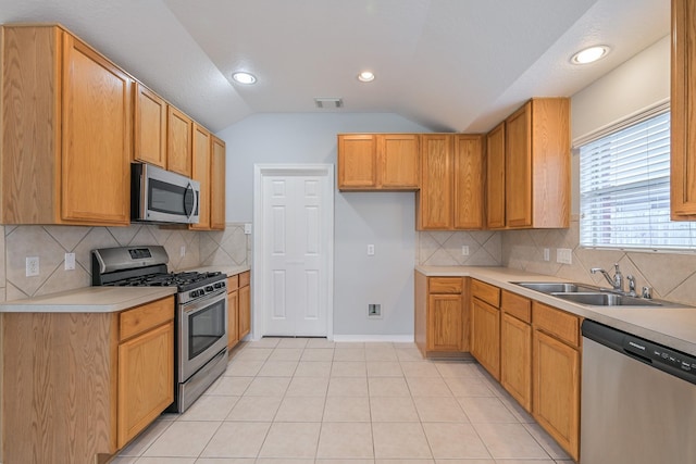 1518 Bugle Run Dr, Katy, TX 77449 - kitchen with stainless steel appliances, vaulted ceiling, light countertops, tasteful backsplash, and recessed lighting