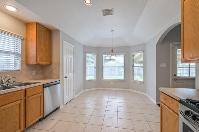 1518 Bugle Run Dr, Katy, TX 77449 - kitchen with appliances with stainless steel finishes, tasteful backsplash, light countertops, arched walkways, and decorative light fixtures