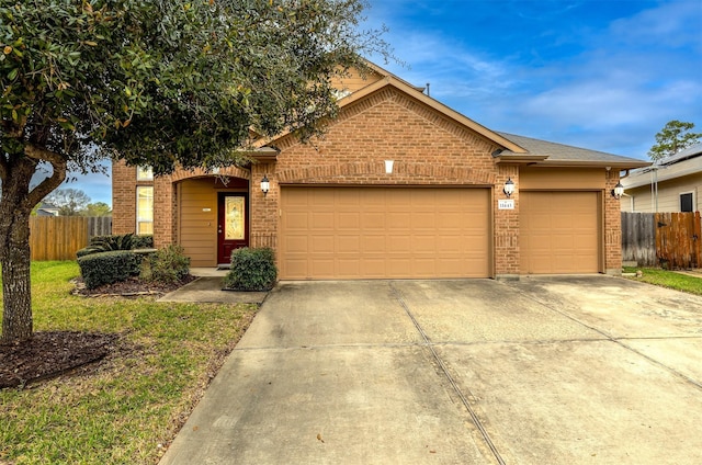 11443 Northam Dr, Tomball, TX 77375 - view of front of home featuring brick siding, driveway, and an attached garage