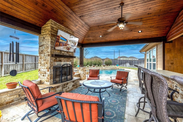 11443 Northam Dr, Tomball, TX 77375 - fenced backyard with an outdoor stone fireplace, a patio, and ceiling fan