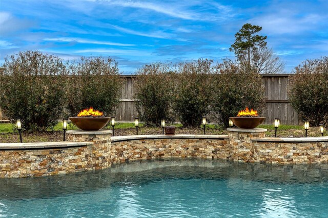 11443 Northam Dr, Tomball, TX 77375 - water view featuring an outdoor fire pit and a fenced backyard