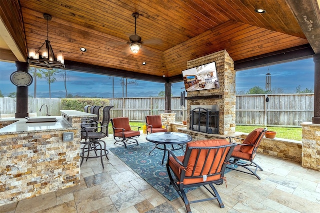 11443 Northam Dr, Tomball, TX 77375 - fenced backyard with an outdoor stone fireplace and a patio area