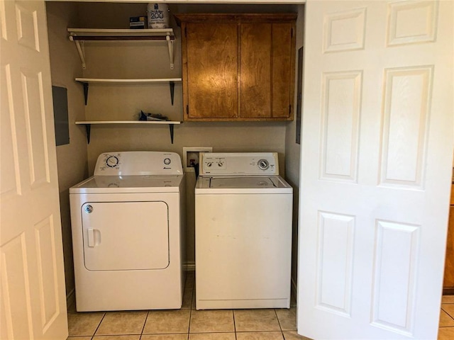 113 Bolero Way, Huntsville, TX 77340 - washroom featuring washing machine and clothes dryer, cabinet space, and light tile patterned floors