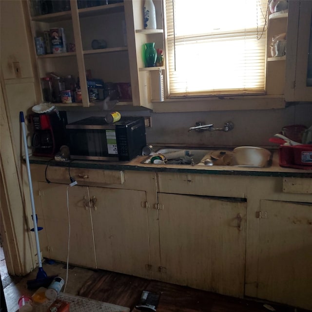 3607 Penn St, Houston, TX 77093 - kitchen with open shelves, black microwave, and white cabinetry