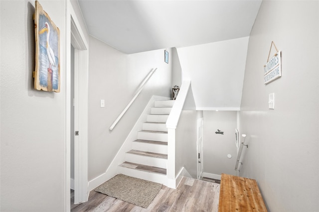 17711 Termini San Luis Pass Rd, Galveston, TX 77554 - staircase featuring wood finished floors and baseboards