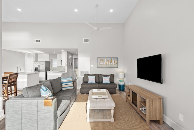 17711 Termini San Luis Pass Rd, Galveston, TX 77554 - living area featuring recessed lighting, ceiling fan, light wood-type flooring, and a high ceiling
