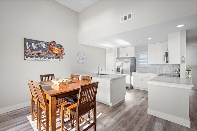 17711 Termini San Luis Pass Rd, Galveston, TX 77554 - dining area featuring light wood-style floors, recessed lighting, and high vaulted ceiling