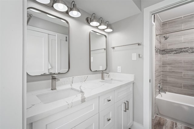 17711 Termini San Luis Pass Rd, Galveston, TX 77554 - bathroom featuring double vanity, bathtub / shower combination, and wood finished floors