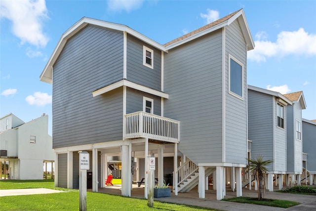 17711 Termini San Luis Pass Rd, Galveston, TX 77554 - back of property with stairway and a lawn