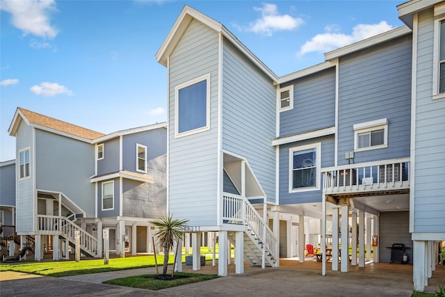 17711 Termini San Luis Pass Rd, Galveston, TX 77554 - view of front facade featuring a carport and stairs