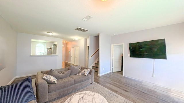 1855 Garnet Breeze Dr, Rosharon, TX 77583 - living room with stairs and light wood-style flooring