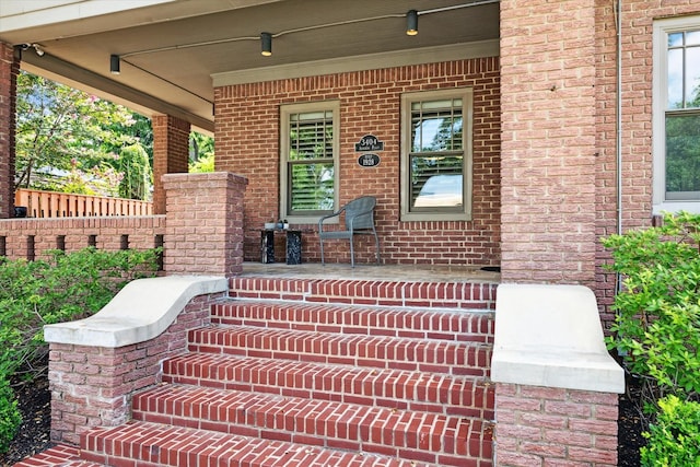 3404 Audubon Pl, Houston, TX 77006 - view of exterior entry featuring covered porch and brick siding