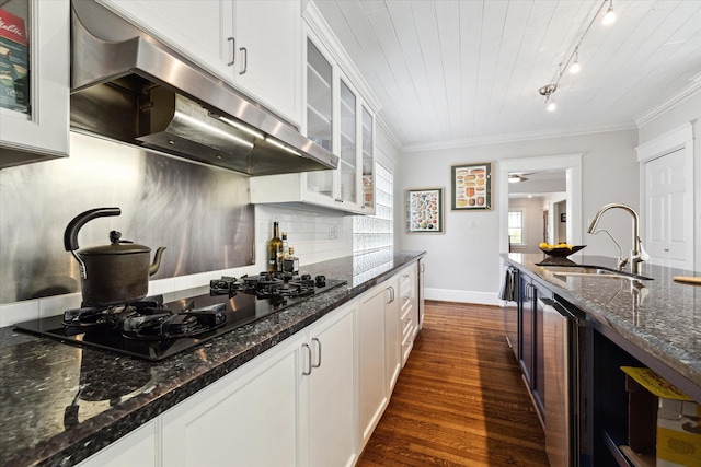 3404 Audubon Pl, Houston, TX 77006 - kitchen featuring extractor fan, black gas stovetop, wine cooler, dark wood-type flooring, and track lighting
