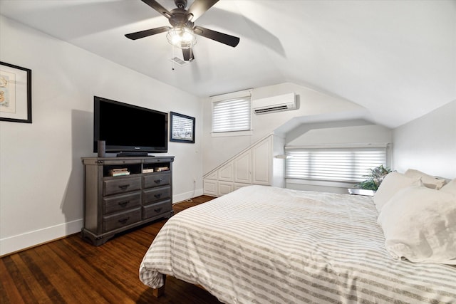 3404 Audubon Pl, Houston, TX 77006 - bedroom featuring a wall mounted AC, dark wood-style floors, vaulted ceiling, and ceiling fan