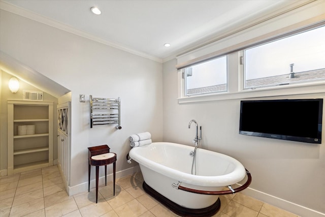 3404 Audubon Pl, Houston, TX 77006 - bathroom featuring a freestanding tub, ornamental molding, a towel warmer, tile patterned flooring, and radiator