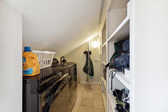3404 Audubon Pl, Houston, TX 77006 - washroom with washing machine and clothes dryer and light tile patterned floors