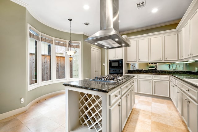 2217 Dunraven Ln, Houston, TX 77019 - kitchen with island exhaust hood, black appliances, white cabinetry, crown molding, and pendant lighting
