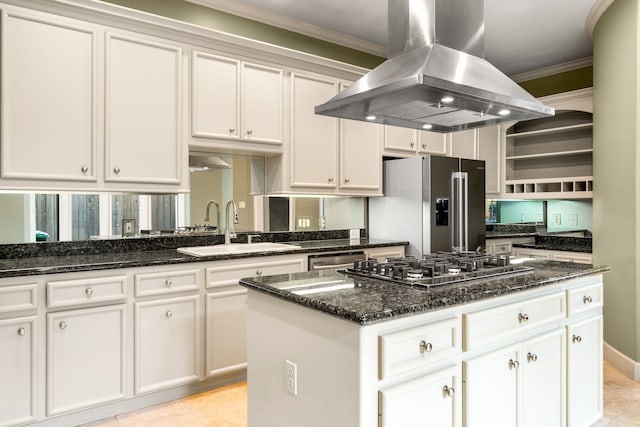 2217 Dunraven Ln, Houston, TX 77019 - kitchen featuring island range hood, stainless steel appliances, open shelves, ornamental molding, and white cabinets