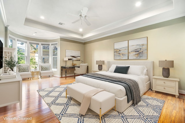 2217 Dunraven Ln, Houston, TX 77019 - bedroom featuring a raised ceiling, ornamental molding, light wood-style flooring, and recessed lighting