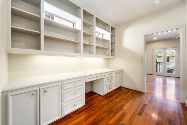 2217 Dunraven Ln, Houston, TX 77019 - unfurnished office featuring built in desk, dark wood-style floors, ornamental molding, and french doors