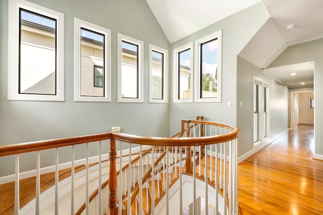 2217 Dunraven Ln, Houston, TX 77019 - hall with an upstairs landing, vaulted ceiling, light wood finished floors, and ornamental molding