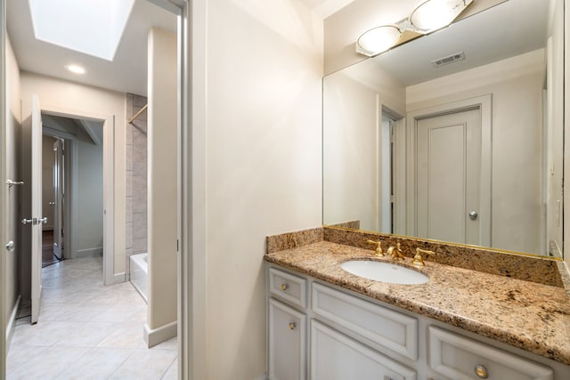 2217 Dunraven Ln, Houston, TX 77019 - bathroom featuring vanity, tile patterned flooring, a skylight, shower / tub combination, and recessed lighting