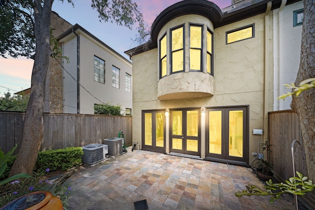 2217 Dunraven Ln, Houston, TX 77019 - back of house featuring a patio area, stucco siding, a fenced backyard, and french doors