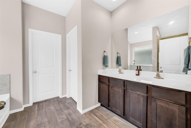 4310 Fornari Ln, Katy, TX 77449 - full bathroom with double vanity and wood finished floors