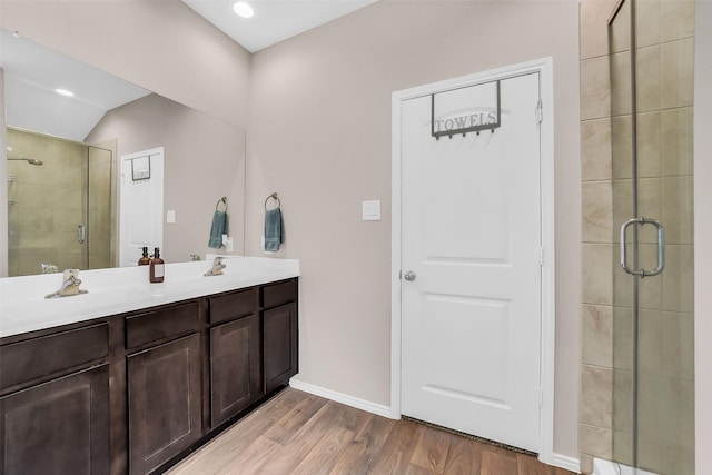 4310 Fornari Ln, Katy, TX 77449 - bathroom with a shower stall, wood finished floors, double vanity, and recessed lighting
