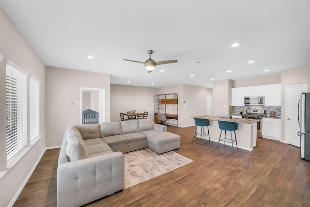 4310 Fornari Ln, Katy, TX 77449 - living area with dark wood-style floors, a ceiling fan, and recessed lighting