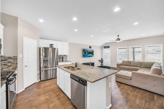 4310 Fornari Ln, Katy, TX 77449 - kitchen with appliances with stainless steel finishes, backsplash, open floor plan, ceiling fan, and recessed lighting
