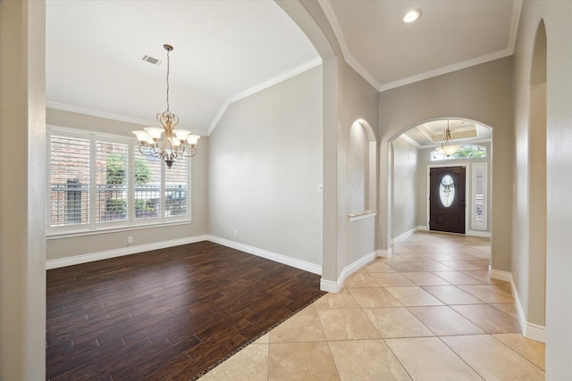 2508 Siskin Trl, League City, TX 77573 - entryway with a chandelier, arched walkways, lofted ceiling, wood finished floors, and ornamental molding